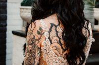 a cute wedding dress that helps to show off bride’s tattoos