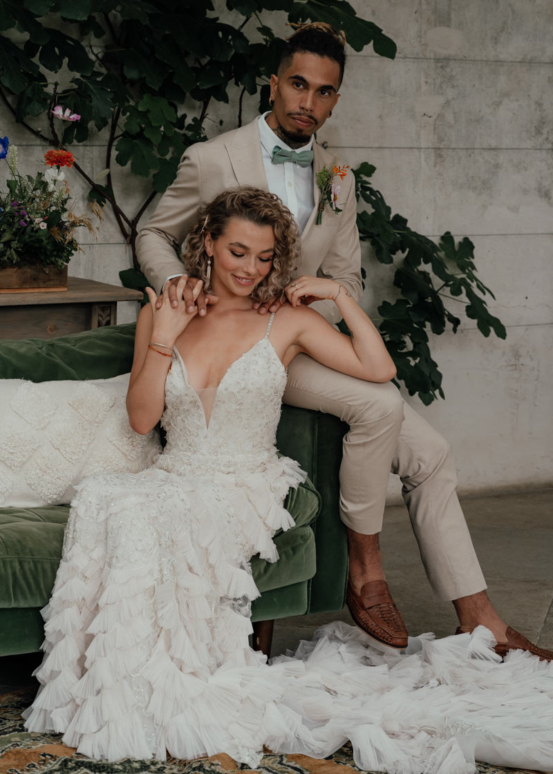The groom was wearing a tan suit, brown moccasins and a green bow tie, the bride was rocking an embellished mermaid wedding dress with ruffles and a train