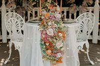 04 The wedding tablescape was done with neutral linens and a candy-colored floral table runner