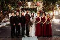 05 The bridesmids were wearing burgundy A-line maxi dresses and the groomsmen were rocking black tuxes and burgundy ties