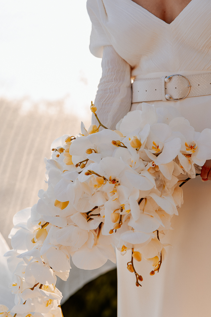 The wedding bouquet was made of white orchids and looked very refined