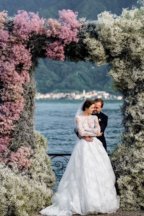 a lush ombre floral wedding arch from white to pink and back to white is a unique idea to rock on your big day