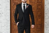 06 The groom was rocking a classic black look with a bold boutonniere