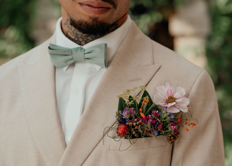 The groom was wearing a floral pocketsquare with greenery