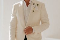 06 The groom was wearing a simple look of a white shirt, a neutral blazer, black pants and an orchid boutonniere