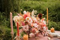 06 The wedding tables was laid with a mauve tablecloth, some pink blooms, colored candles and gold cutlery and chargers