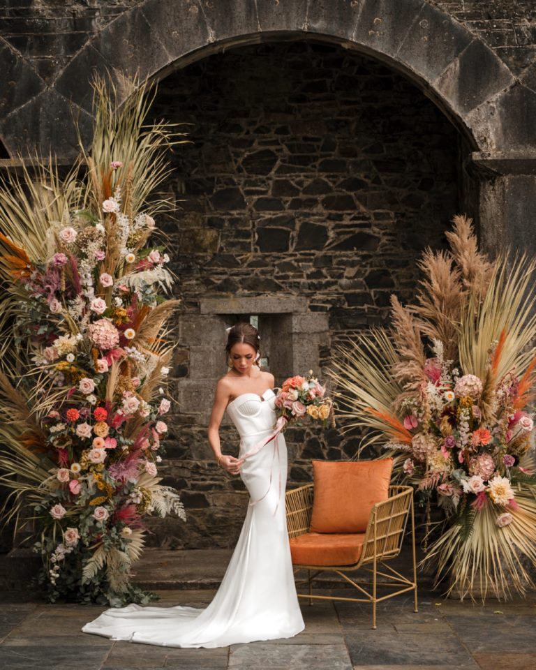 The wedding altar was jaw dropping, with bold and pastle blooms, dried fronds and leaves
