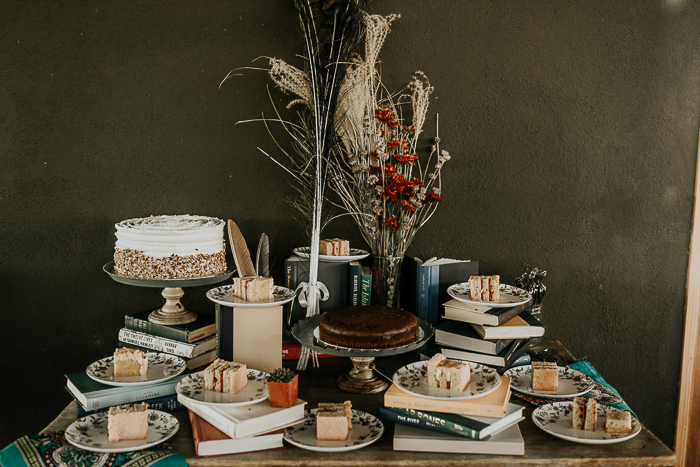 The wedding dessert table was done with dried blooms and vintage books and looked cool
