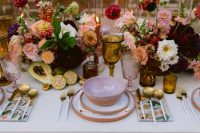 10 The reception table showed off lush florals, fruits, candles for decor and lovely printed plates and bowls