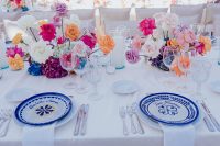 10 The tablescape was done with super bright blooms, candles and patterned plates
