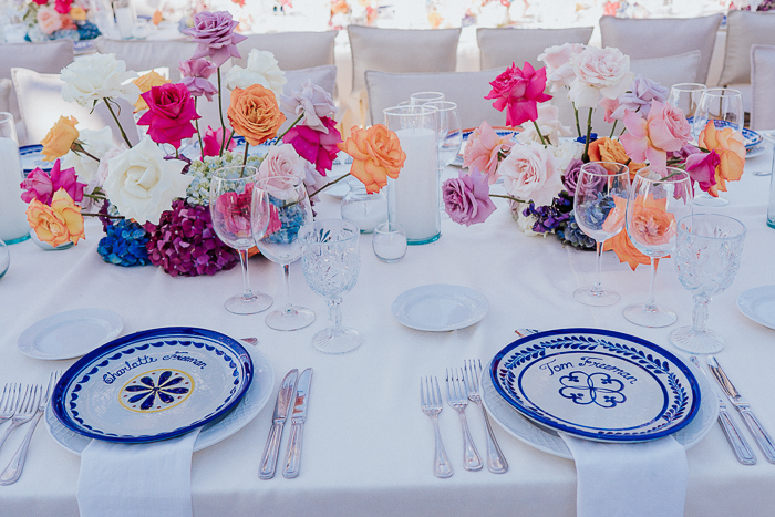 The tablescape was done with super bright blooms, candles and patterned plates