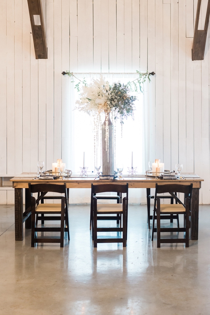 The wedding tablescape was crowned with a super tall centerpiece of usual and dried foliage