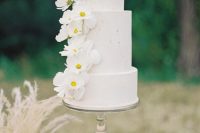 11 The wedding cake was a white textural one, with white fresh blooms for decor