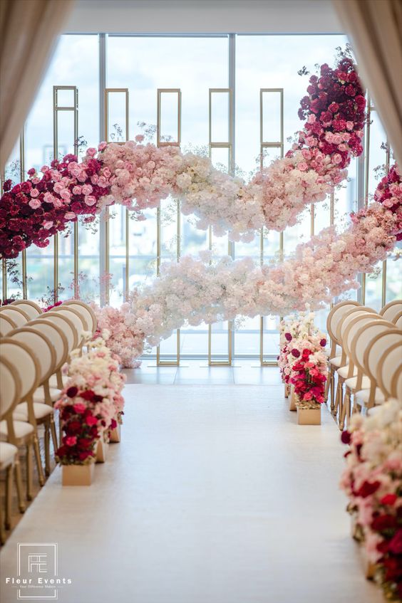 a jaw dropping wedding backdrop made of ombre garlands of blooms is a gorgeous idea to make a statement in your ceremony space