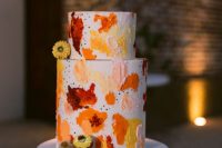 12 The wedding cake was done with bright splashes and dried blooms to continue with a war color palette