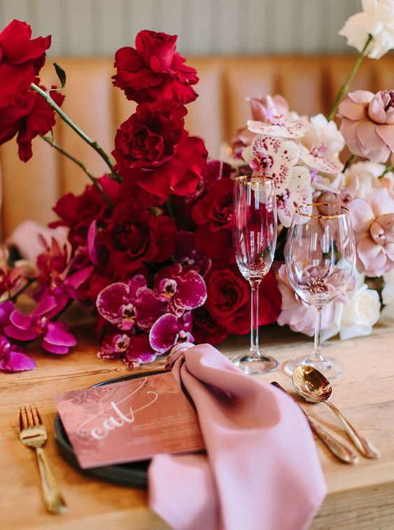 15 a beautiful wedding centerpiece from hot pink to red and blush, completely of orchids is a very refined idea