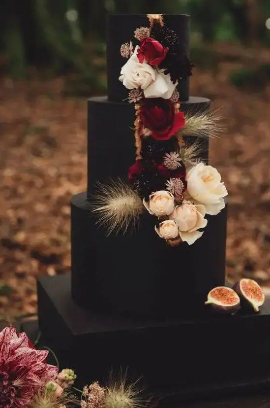 a black wedding cake with neutral, deep red and dark blooms, dried wheat and dried flowers is a lovely idea for a fall boho wedding