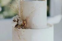 a blush marble textural wedding cake with gold leaf, dried blooms and herbs is a very refined idea for a delicate and formal summer wedding
