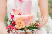 a bright pastel watercolor wedding cake decorated with pastel and bold blooms and with greenery is a gorgeous idea