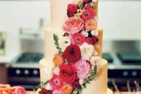 a fantastic plain five tier wedding cake with bold red, burgundy, pink and neutral blooms is a beautiful statement to make