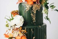 a gorgeous dark green wedding cake with matchign drip and bold orange and white blooms and greenery looks jaw-dropping