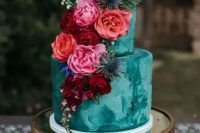 a gorgeous emerald textural wedding cake decorated with red, orange, burgundy, hot pink blooms and foliage for a colorful wedding in the fall