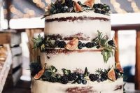 a gorgeous fall naked wedidng cake decorated with blackberries, blueberries, figs and greenery looks very yummy