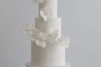 a minimalist white wedding cake decorated with white orchids is a very refined and chic idea for any minimalist wedding