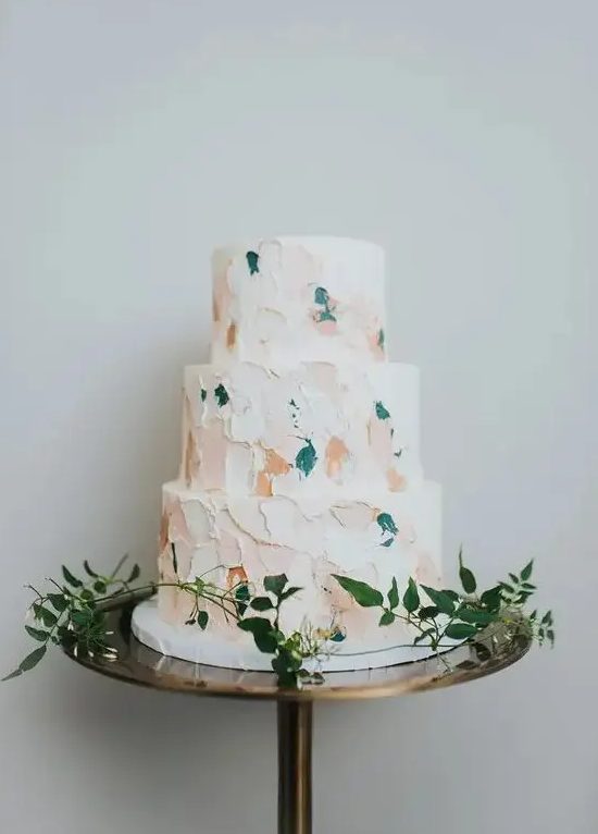 A modern wedding cake with pastel and teal brushstrokes is a fresh idea for a modern wedding and it looks non boring