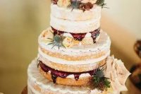 a naked wedding cake with raspberry mousse inside, blush, cream and orange blooms and thistles