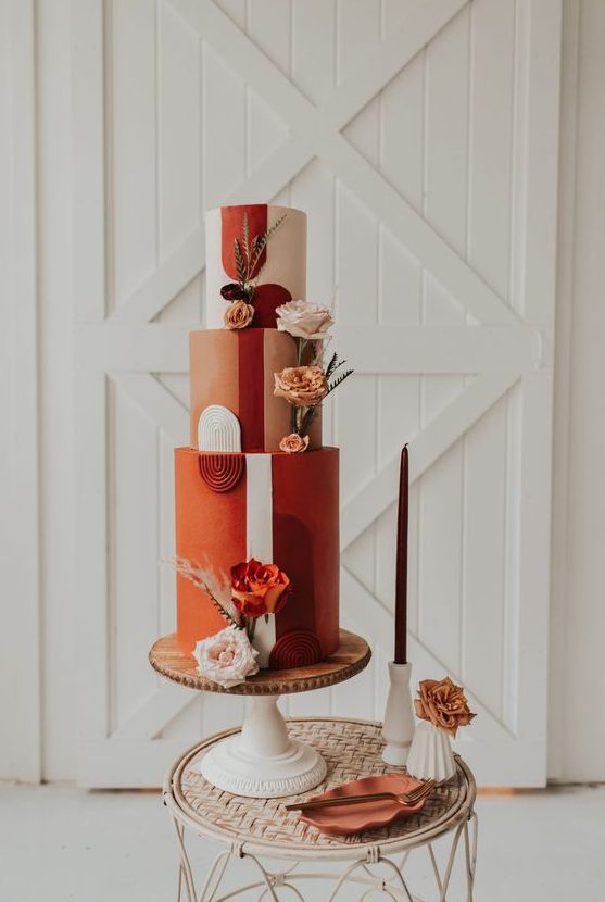 a refined 70s wedding cake with a blush, terracotta and rust tier, fresh and dried blooms and pampas grass is amazing
