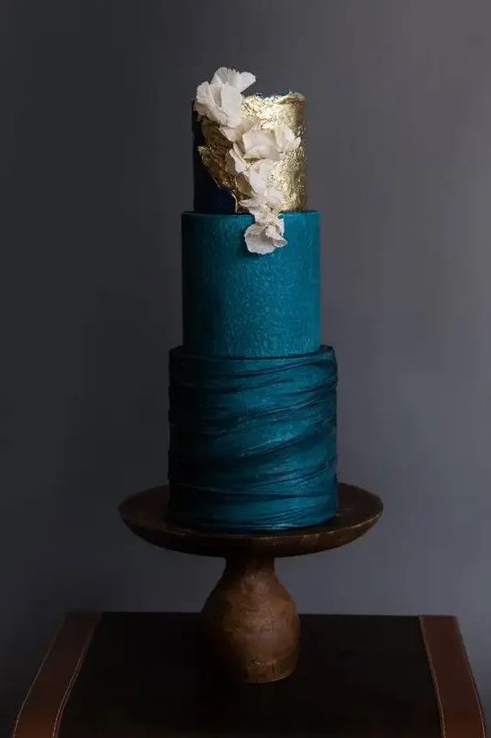 a sophisticated navy blue wedding cake with textural tiers, gold leaf and blush blooms is a very chic and very stylish idea for a modern wedding