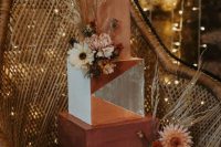 a statement square wedding cake with a terraccotta, rust and color block tier, dried blooms and pampas grass is amazing