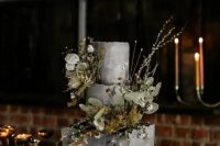 a textural grey square and round wedding cake with dried blooms, greenery and some fresh flowers is a real masterpiece