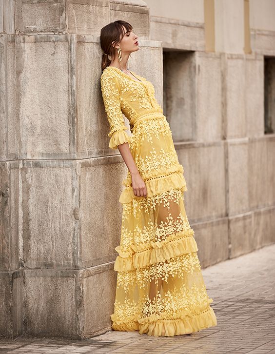 a unique yellow boho A-line wedding dress with floral appliques and ruffles, with short sleeves and a V-neckline