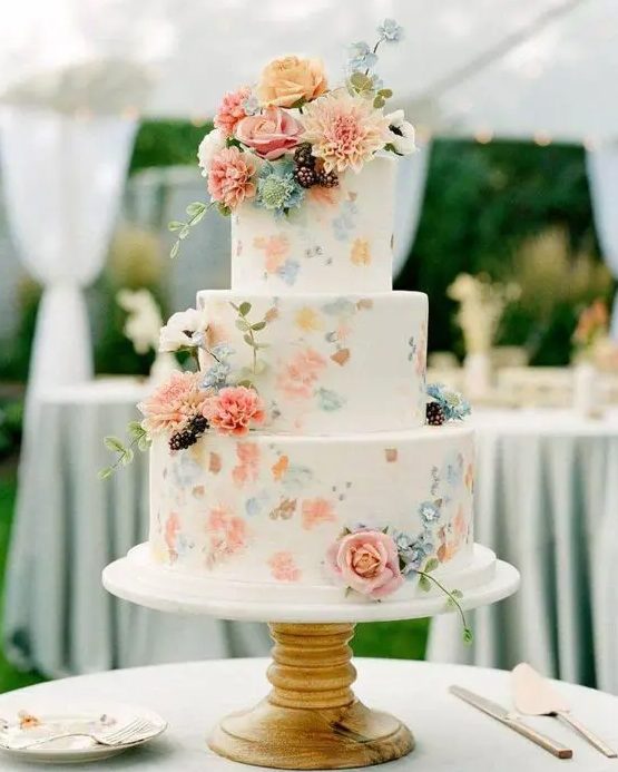 a white buttercream wedding cake with painted pastel blooms and real fresh ones is a perfect solution for spring and summer