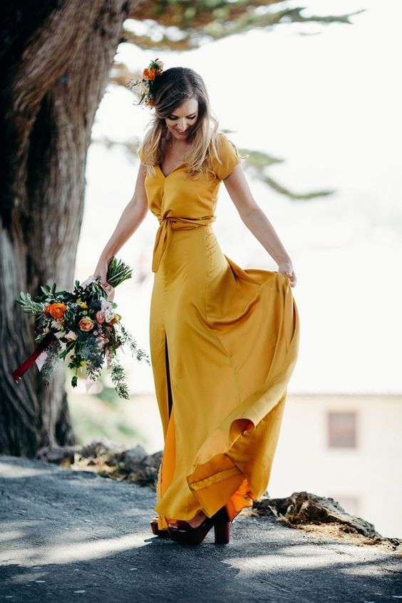 a yellow wedding dress with a tied up bodice, an A line skirt with a front slit plus paltform shoes for a boho bride