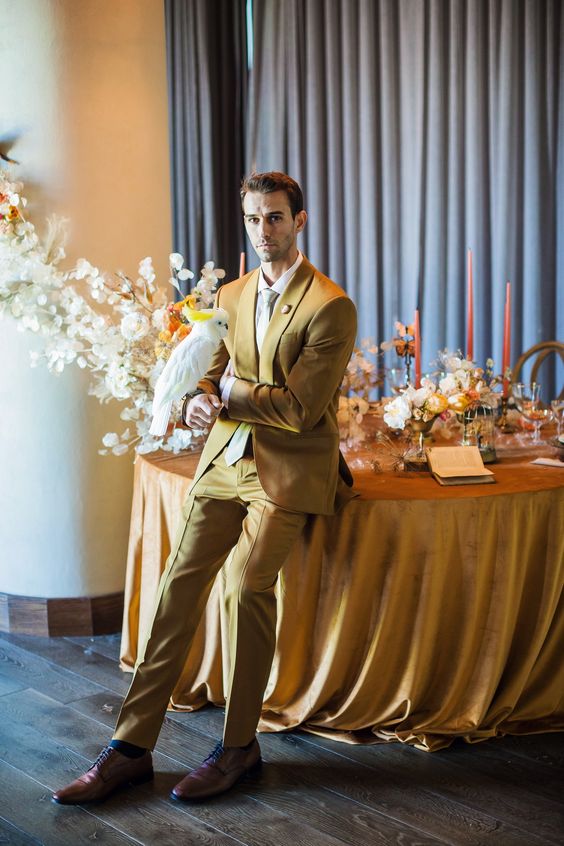 a stylish look with a yellow suit, a white shirt and white tie, brown shoes and blue socks for a summer wedding