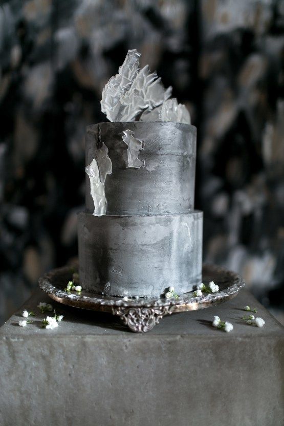 a grey concrete wedding cake with glass-like shards on top for a minimalist or modern wedding