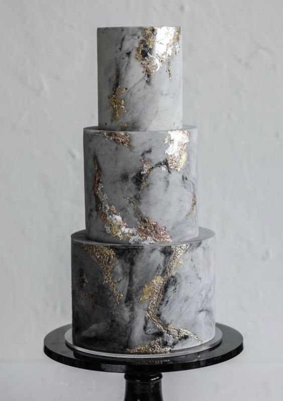 a grey marble wedding cake with different shades of grey and gold foil is a lovely idea for a modern and refined wedding