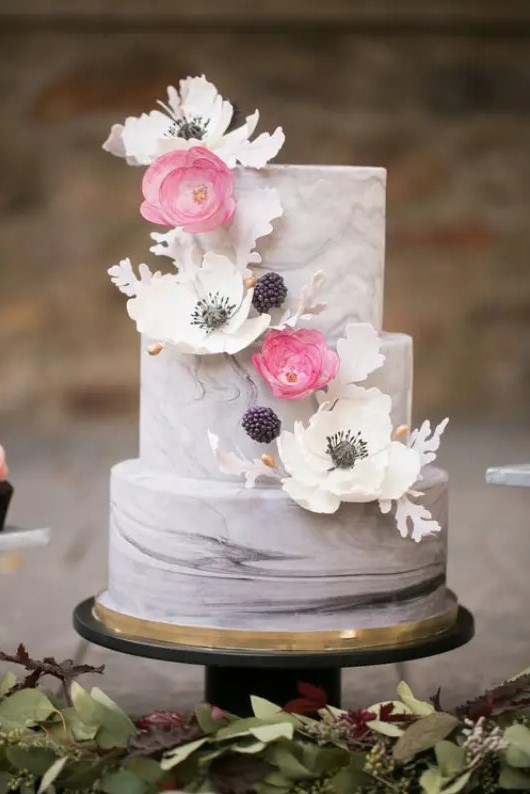 a grey marble wedding cake with fresh and sugar blooms, berries and sugar leaves is a beautiful solution for spring or summer