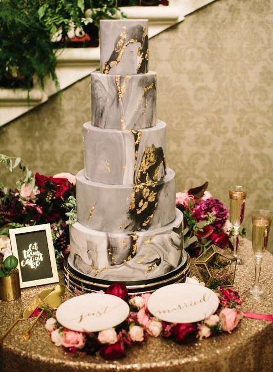 a grey marble wedding cake with gold leaf is a stylish and statement idea for a modern refined wedding