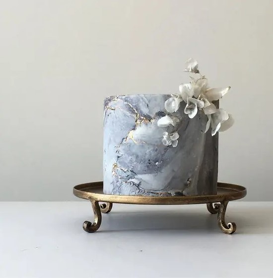 a grey marble wedding cake with rice paper flowers looks like a real masterpiece, delicate and fantastic
