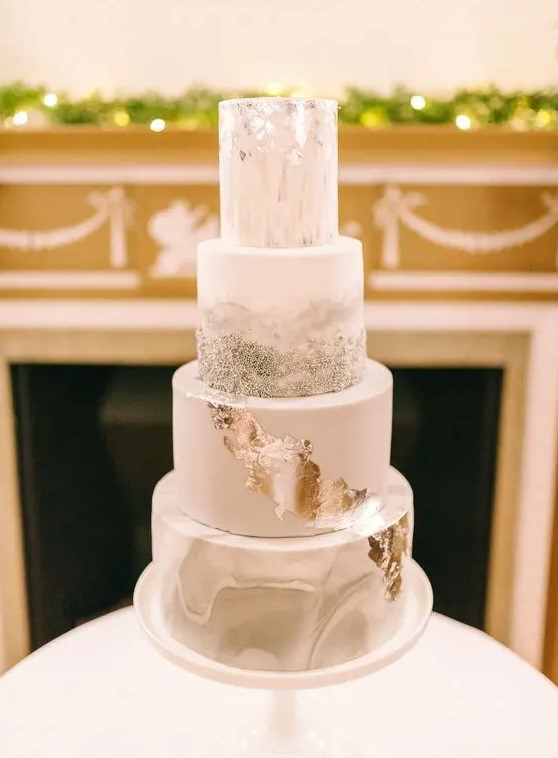 a lovely wedding cake with a grey marble, white, silver glitter and silver leaf tier is a gorgeous and shiny idea for a winter wedding
