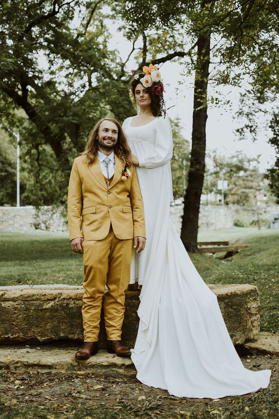 A mustard three piece suit, a white shirt, a bolo tie, brown shoes are a great combo for a boho wedding