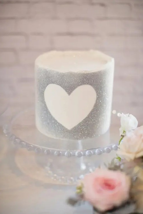 a silver grey wedding cake with a heart is a cool glam dessert for your wedding, it will be perfect for a NYE wedding