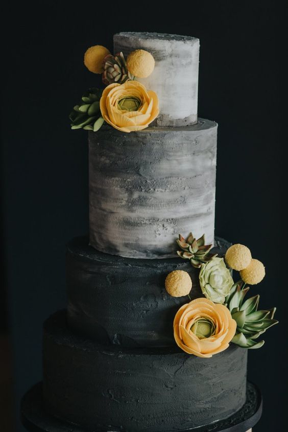 a textured grey and black wedding cake decorated with succulents, billy balls and yellow ranunculus is a bold and contrasting piece