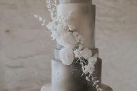 an airy grey and white wedding cake with watercolors, white sugar and natural blooms is a very chic and elegant idea