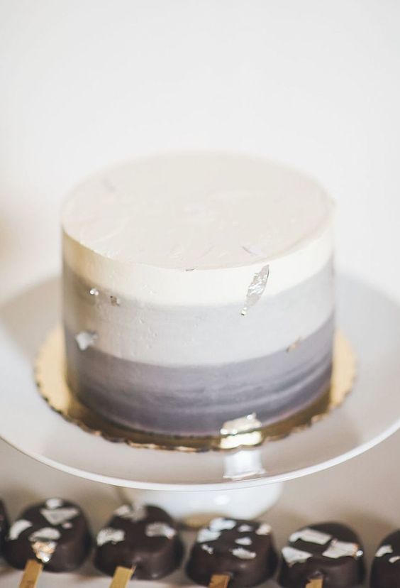 An ombre wedding cake from white to grey, with silver foil is a stylish and eye catchy wedding idea