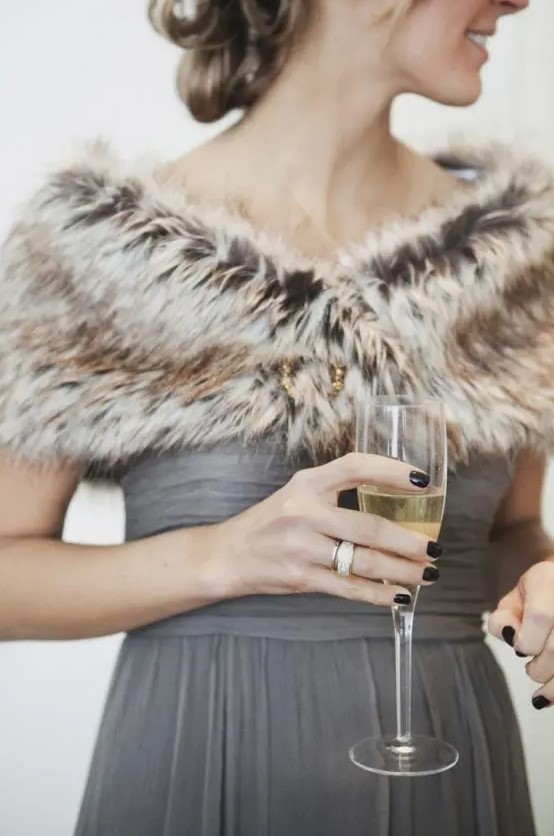 grey bridesmaid's dress looks awesome with a brown faux fur stole, which keeps the girl warm
